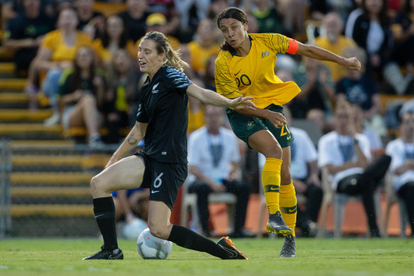 Football Ferns star Rebekah Stott blocks a shot from Matildas skipper Sam Kerr.