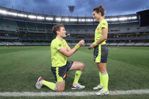 AFL umpire Dillon Lee asks ALF first field umpire Eleni Glouftsis to marry him after the Blues and Crows game at the MCG.