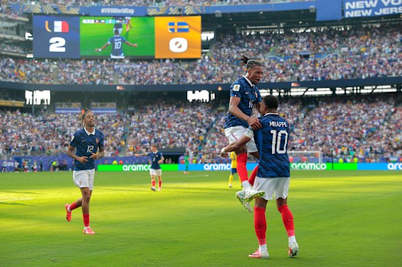 Kylian Mbappe (10) and Michael Olise (11) celebrate.
