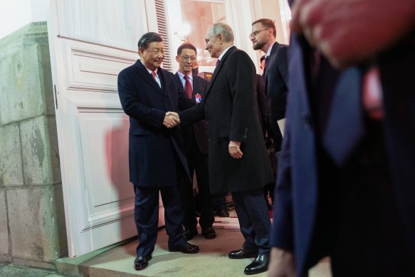 Chinese President Xi Jinping, left, shakes hands with Russian President Vladimir Putin as he leaves after their dinner at The Palace of the Facets in the Kremlin.