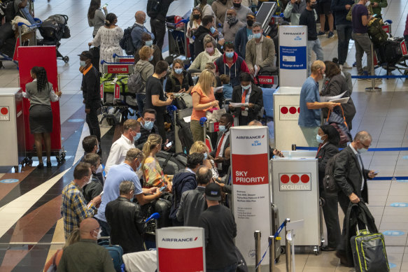 People queue to get on an Air France flight to Paris at the O.R. Tambo airport in Johannesburg last week. 