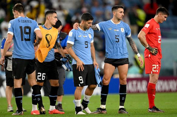 Uruguay players show dejection after the team fails to qualify for the knockout stage.