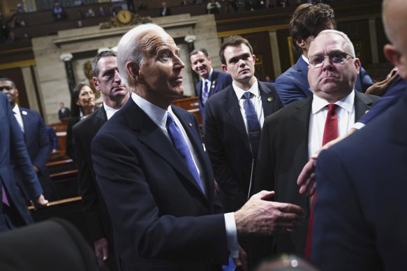 US President Joe Biden (left) departs after delivering the State of the Union address.