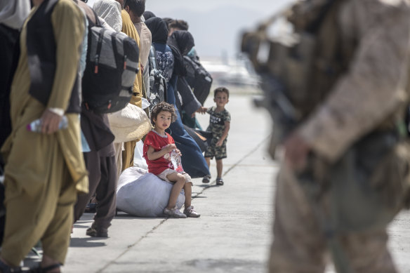 A child waits with her family to board a US evacuation flight at Kabul airport on August 22.