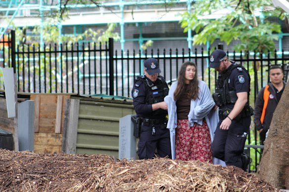 Sharai Lancaster was removed by police and taken to a nearby ambulance wrapped in a blanket. 