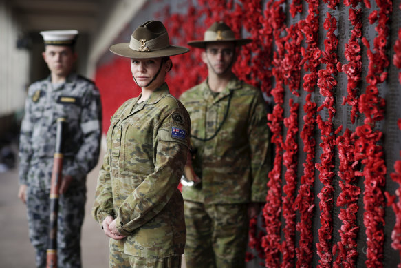 Rachel MacCallum (centre) will sing the national anthem with the Australian Army band at an empty War Memorial in Canberra.