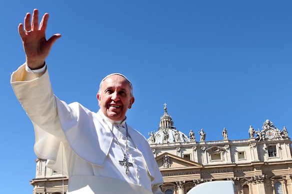Pope Francis waves to the faithful as he leaves St Peter’s Square at the end of Palm Sunday Mass on March 29, 2015.