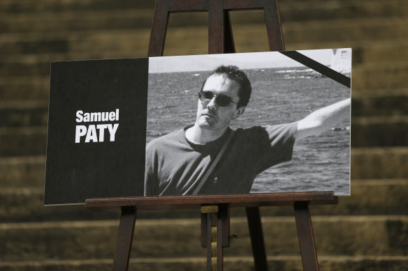 The portrait of slain teacher Samuel Paty is displayed on the steps of the National Assembly in Paris.