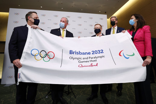Brisbane Lord Mayor Adrian Schrinner, Federal Sports Minister Richard Colbeck, AOC president John Coates, Olympian James Tomkins and Queensland Premier Annastacia Palaszczuk celebrate in Tokyo.