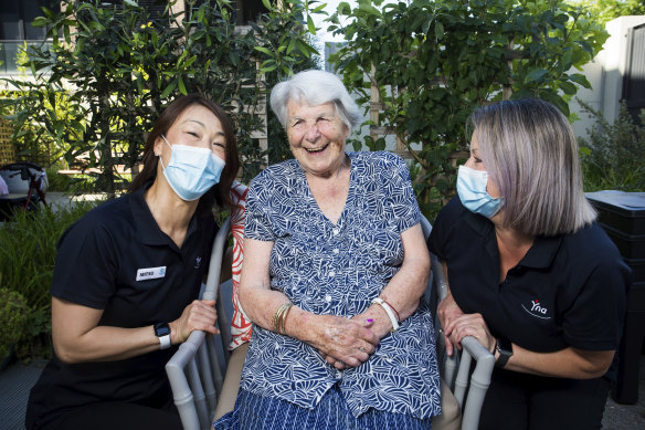 Aviation industry workers Mitsu Kamo (left) and Louise Mathers, with Regis Aged Care resident Jean Sarsby, have been hired  under a new program to help organise visits for nursing home residents. 