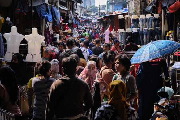 Indonesians crowd the Tanah Abang textile market to buy new clothing, a tradition for upcoming the Eid al Fitr holiday in Jakarta, Indonesia.