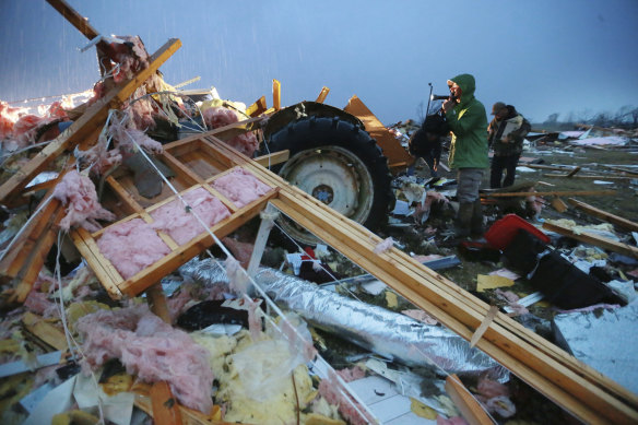 Volunteers search debris and try to salvage what they can from their church, which was destroyed in a tornado in Guntown, Mississippi.