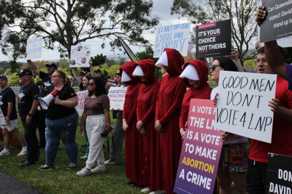 Four people dressed as women from The Handmaid’s Tale were among the 40-odd protesters outside the LNP’s campaign launch.