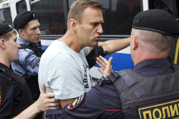Russian police detain opposition politician Alexei Navalny during a march in Moscow in June.