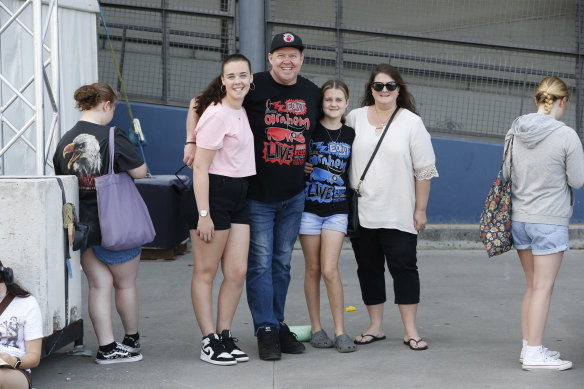Sophia, Mike, Rhiannon and Lauren Rogers from the Northern Territory line up for Harry Styles merchandise outside Marvel Stadium. 