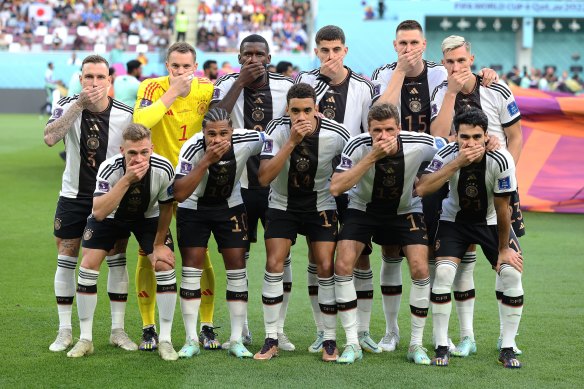 German players cover their mouths ahead of their opening game to protest against FIFA’s refusal to let them wear diversity armbands.