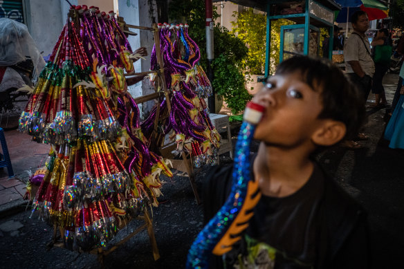 A boy blows a trumpet during new year celebrations in Yogyakarta.