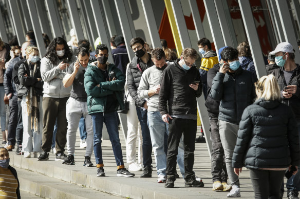 People line up outside the Melbourne Exhibition Centre vaccine hub.