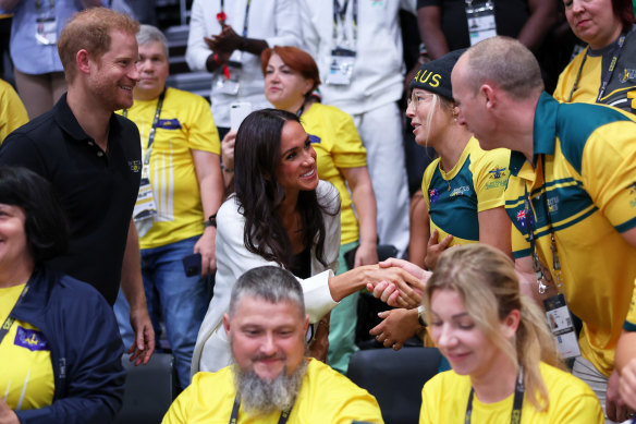 Prince Harry and Meghan chat to members of the Australian contingent.