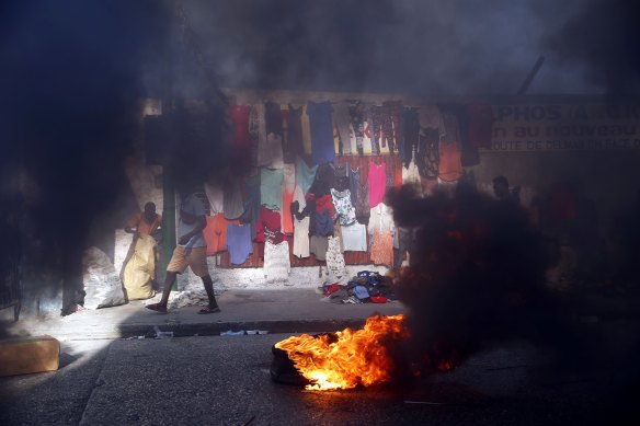 Smoke from tires set fire by protesters fills a street in Delmas during a countrywide strike demanding the resignation of Haitian President Jovenel Moise in Port-au-Prince, Haiti, on February 1.