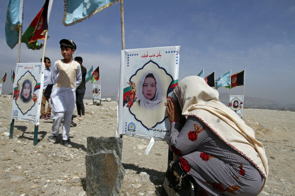 A mother weeps at her daughter’s grave on the outskirts of Kabul as friends and families of students killed in local conflicts gather in a cemetery to call for a permanent countrywide ceasefire.