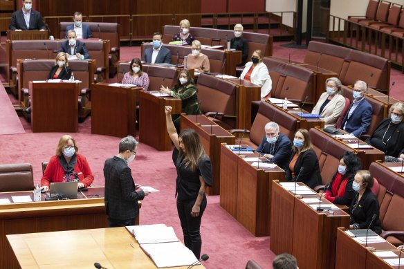 Greens senator Lidia Thorpe stands with her fist raised in the air as she is sworn in to the new Senate.