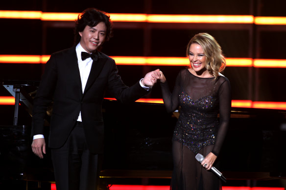 Kylie Minogue (R) with Li Yundi on stage at the Elite Model Look 28th World Final on December 6, 2011 in Shanghai.