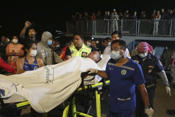 A rescued sailor from HTMS Sukhothai corvette is transferred on land at the Bangsaphan deep port in Prachuap Khiri Khan province.