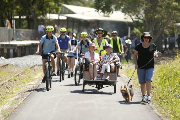 Cyclists and walkers enjoy the Rail Trail at its opening on March 1.