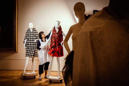 Conservator Viki Car with two pieces from Alexander McQueen’s Horn of Plenty collection that will feature in the NGV exhibition.