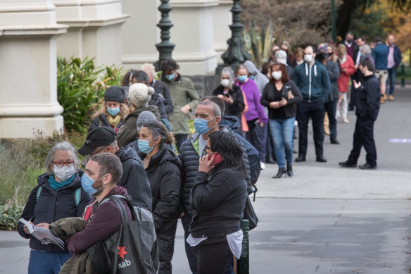 Long lines of people waiting for vaccination at the Exhibition building in Carlton, Melbourne yesterday.