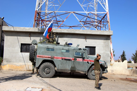 Russian armoured vehicles patrol the Syrian border in Kobani.