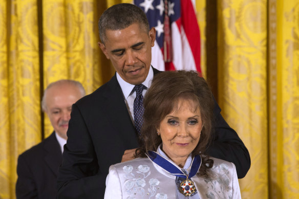 President Barack Obama awards country music legend Loretta Lynn with the Presidential Medal of Freedom in 2013.