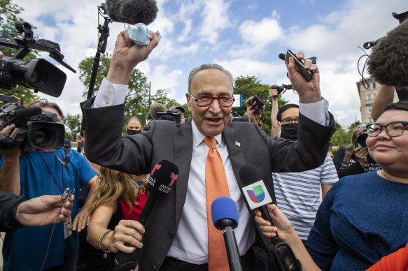 Senate Majority Leader Chuck Schumer celebrates with DACA recipients outside the US Supreme Court.