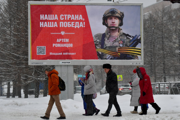 People walk past a billboard honoring a Russian soldier and reading “Our Country, Our Victory!”  In St. Petersburg last month.