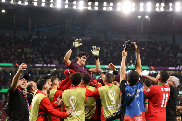 Yassine Bounou of Morocco is tossed into the air after the team’s victory.