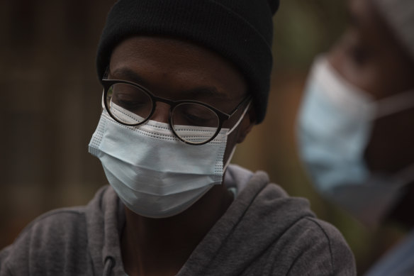 A student from the Tshwane University of Technology wears a face mask outside his residence in Pretoria, South Africa.