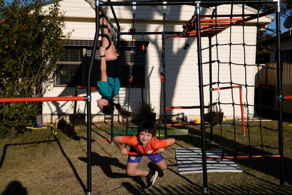 Caitlin and Liam Coyne playing on the new outdoor play equipment yesterday. Their parents bought it when they heard Blacktown council was closing all local playgrounds.