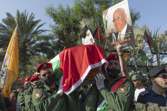 A Palestinian honour guard carries the body of Saeb Erekat into the cemetery during his funeral in the West Bank town of Jericho on Wednesday.