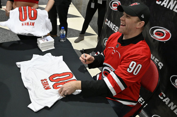 Ayres signs autographs for adoring Hurricanes fans.
