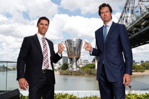 Simon Black and AFL boss Gillon McLachlan show off the premiership cup under Brisbane's Story Bridge.