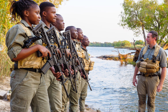 Brian Gurney with members of Matetsi’s anti-poaching unit, who are armed with semi-automatic AR-15 rifles. 