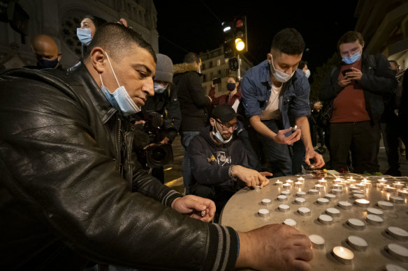 People pay tribute in front of the Notre Dame Basilica in Nice.