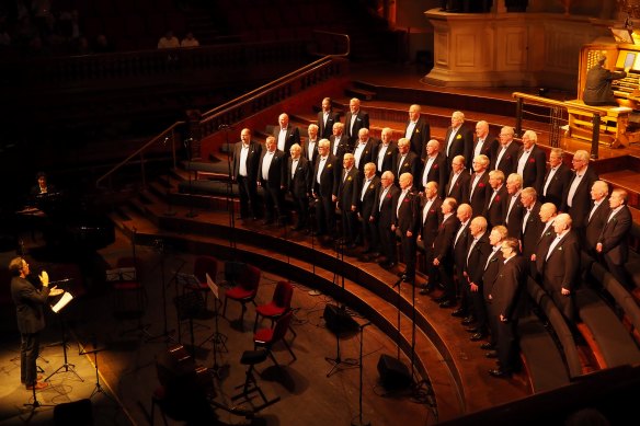 Paul Debono performs on stage with the Sydney Male Choir