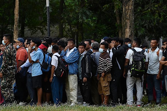 Residents of Dhunge wait to be evacuated by helicopter.