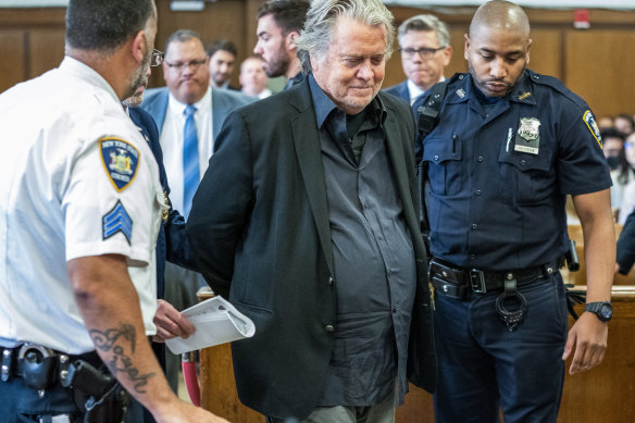 Former White House strategist Steve Bannon, centre, is escorted into the courtroom for his arraignment in Manhattan State Supreme Court after surrendering to authorities in New York.