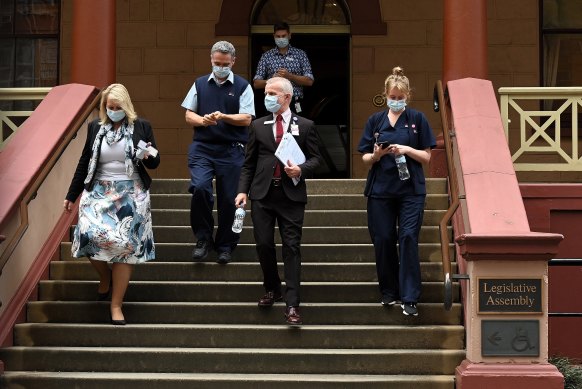 Some members of NSW health leave NSW Parliament House which has suspended after NSW Agriculture Minister Adam Marshall tested positive for COVID-19. 