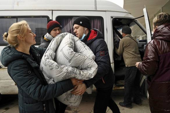 Volunteers unload a van full of bedding for refugees at the Zaporizhzhia Circus.