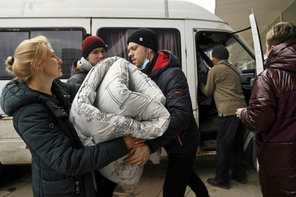 Volunteers unload a van full of bedding at the Zaporizhzhia Circus.