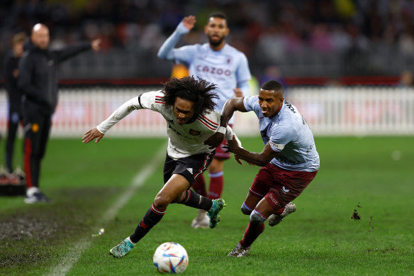 Tahith Chong of Manchester United and Ashley Young of Aston Villa contest for the ball during the Pre-Season Friendly match between Manchester United and Aston Villa at Optus Stadium.
